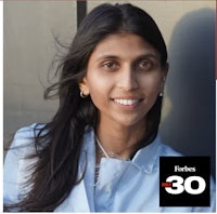 a woman in a blue shirt with a smile on her face
