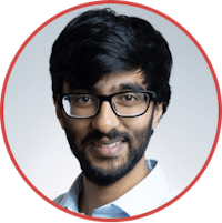 a man with glasses and a beard smiling in a circle