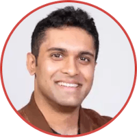 an indian man smiling in a circle